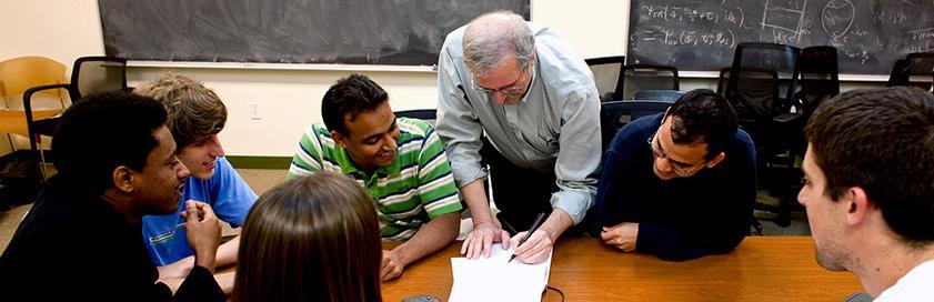 Theory group gathered at a table to discuss theories.